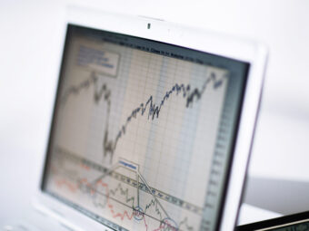 Businessman analyzing investment charts with laptop. Accounting